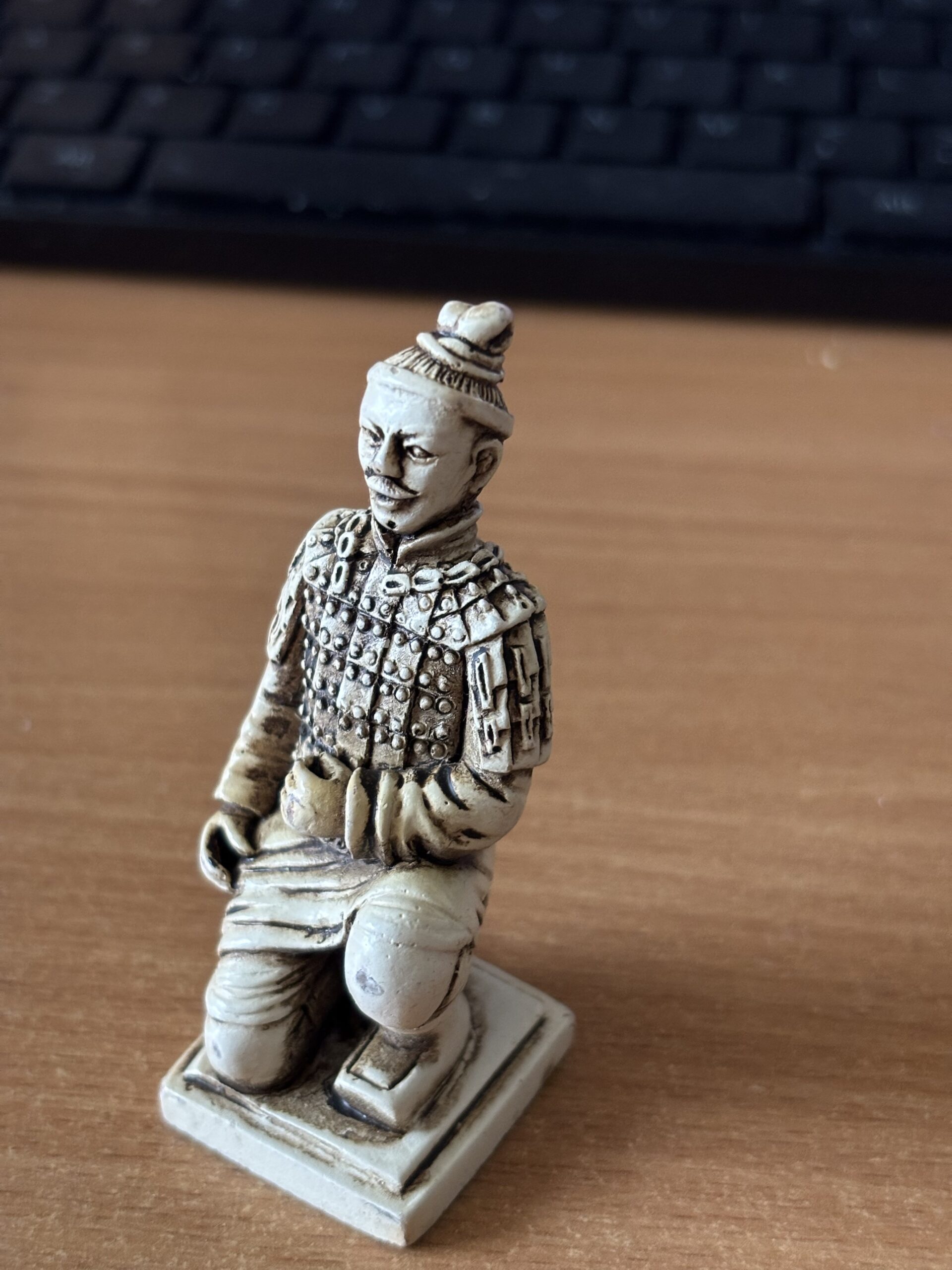Kneeling terracotta warrior chess piece close up