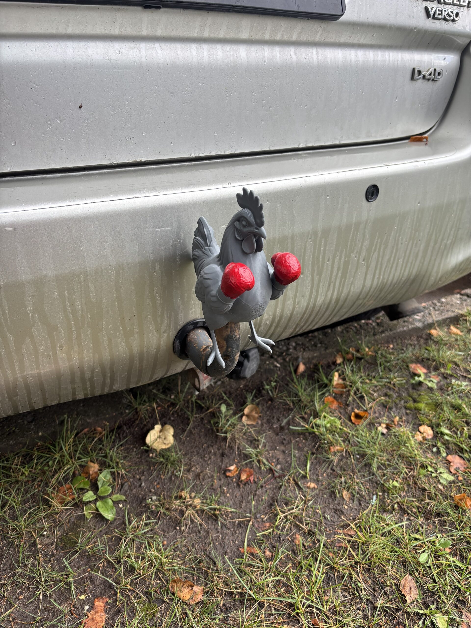 3D printed rooster wearing red boxing gloves mounted on a car tow hook